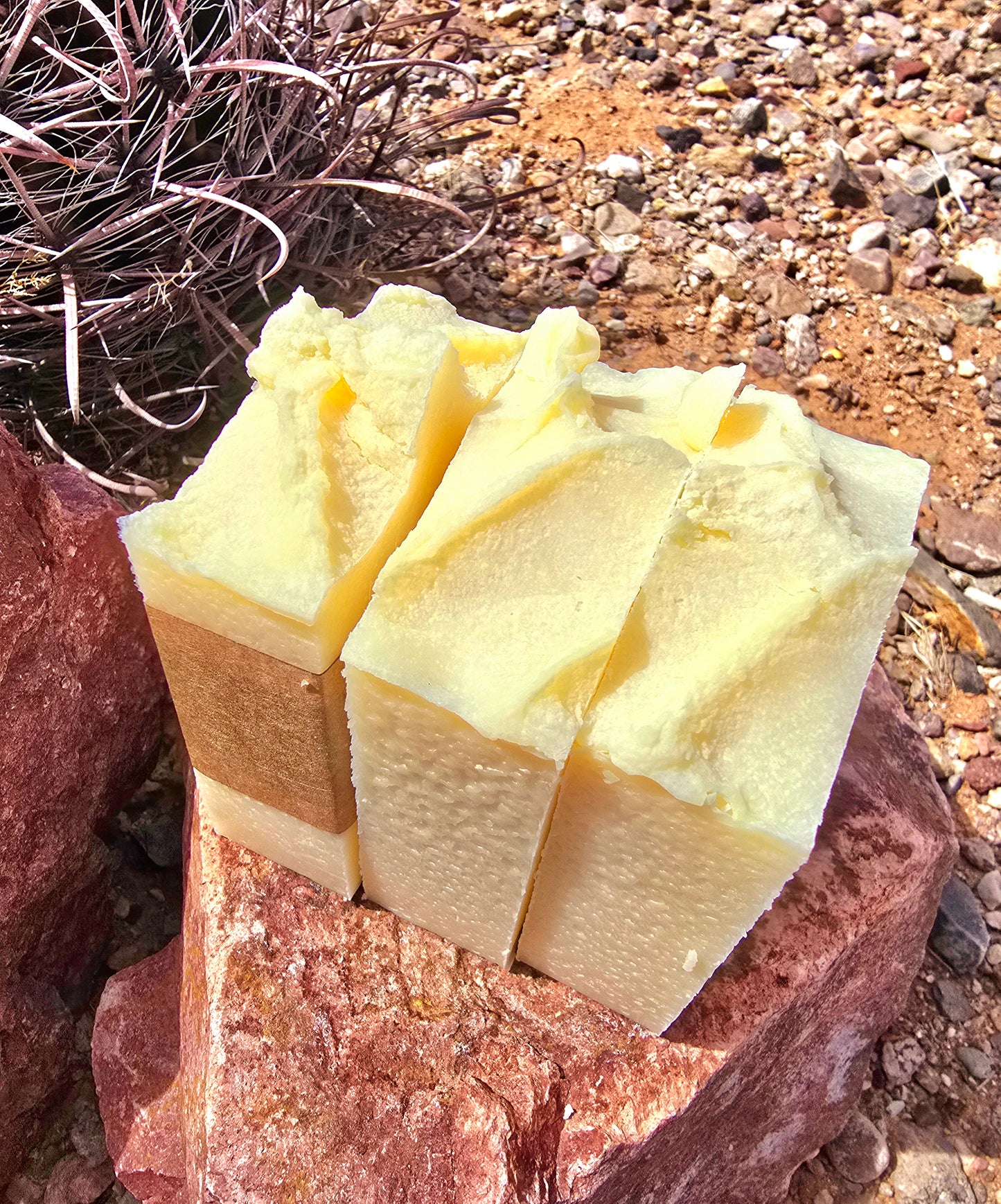 Side view of three handmade soap bars featuring white lily and aloe fragrance, crafted with grass-fed beef tallow, shea butter, and olive oil for deep hydration and gentle cleansing.