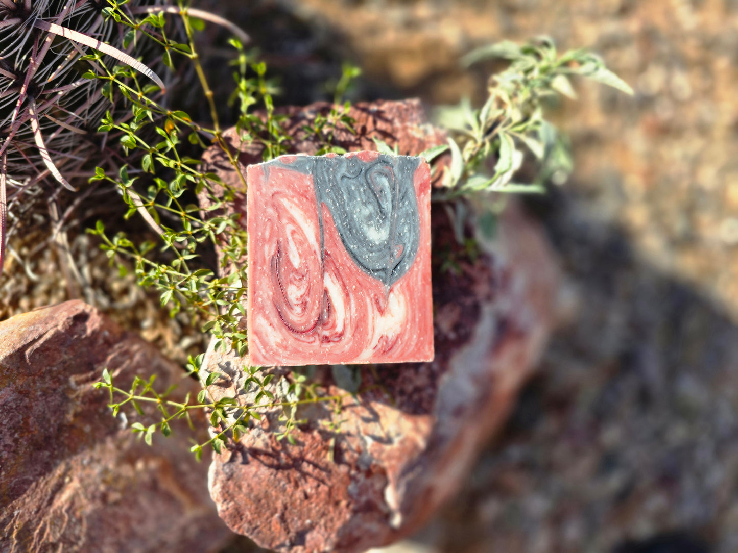 Handmade lard-based soap bar featuring a swirl of red, white, and green colors, infused with a sweet black raspberry and vanilla fragrance for a creamy lather