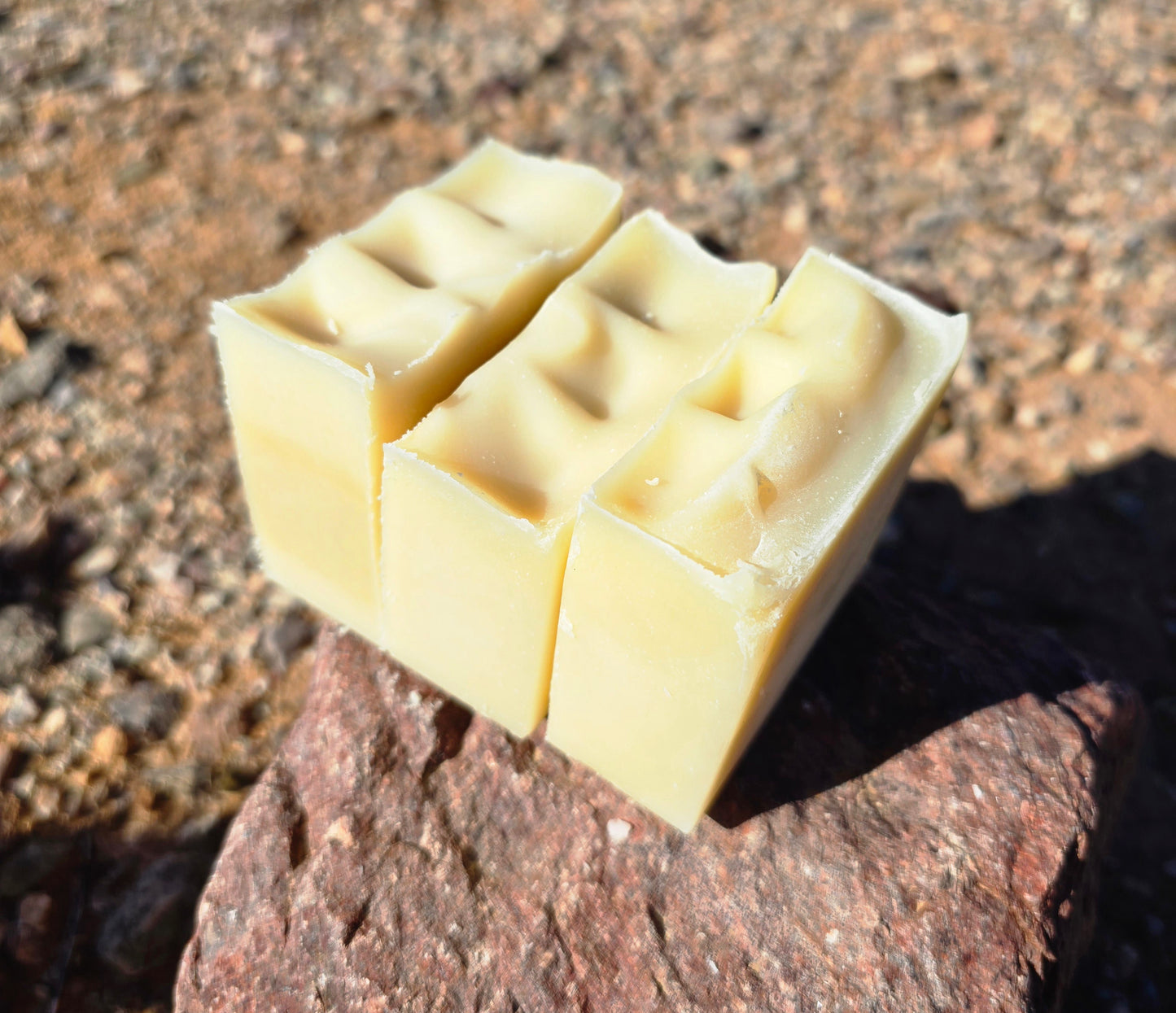 Handmade goat milk soap bar infused with chamomile fragrance, crafted with grass-fed beef tallow, organic shea butter, and avocado oil for deep hydration and gentle cleansing.