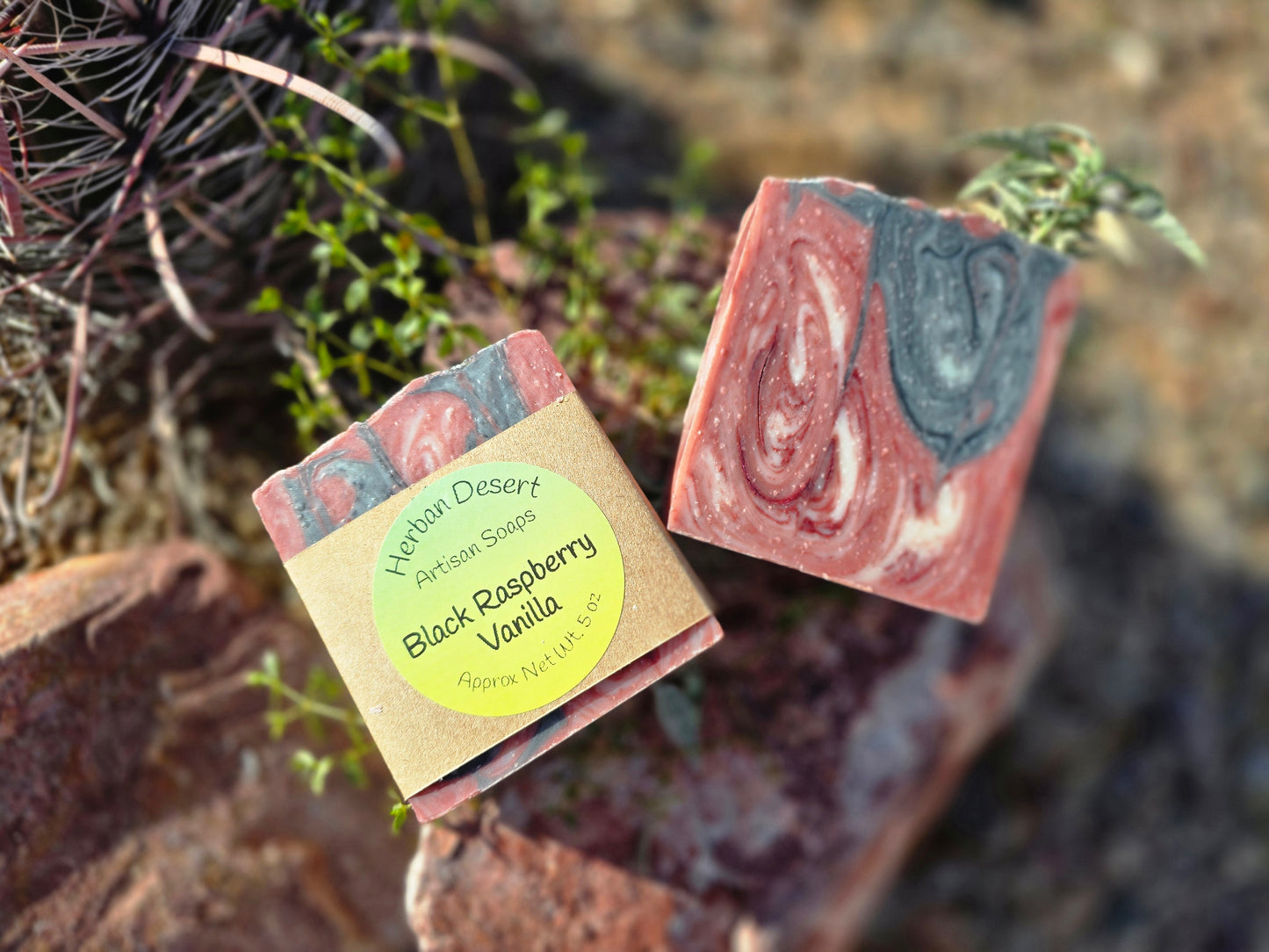 Handmade lard-based soap bar featuring a swirl of red, white, and green colors, infused with a sweet black raspberry and vanilla fragrance for a creamy lather.