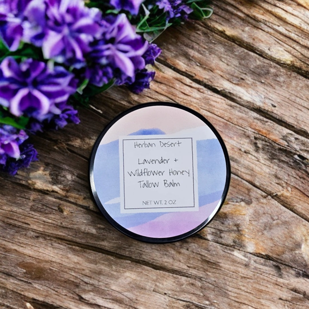 Herban Desert's Lavender & Wildflower Honey Tallow Balm jar with multi color lid, set against a rustic wooden background, showcasing its all-natural ingredients