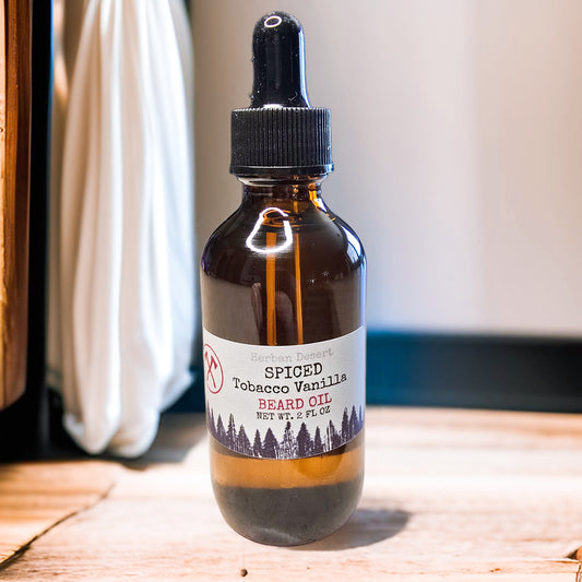Bottle of spiced tobacco vanilla beard oil on a wooden surface with a blurred background
