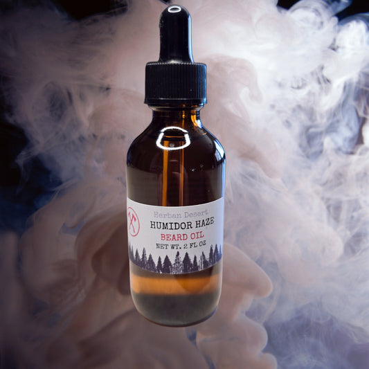 Bottle of Humidor Haze Beard Oil with a label on a smoky background