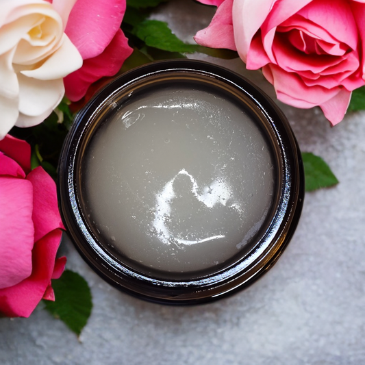 Jar of tallow moisturizer cream with pink and white roses on a light background