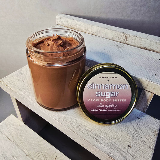 Herban Desert cinnamon sugar glow body butter jar. Creamy texture shows off shimmers.